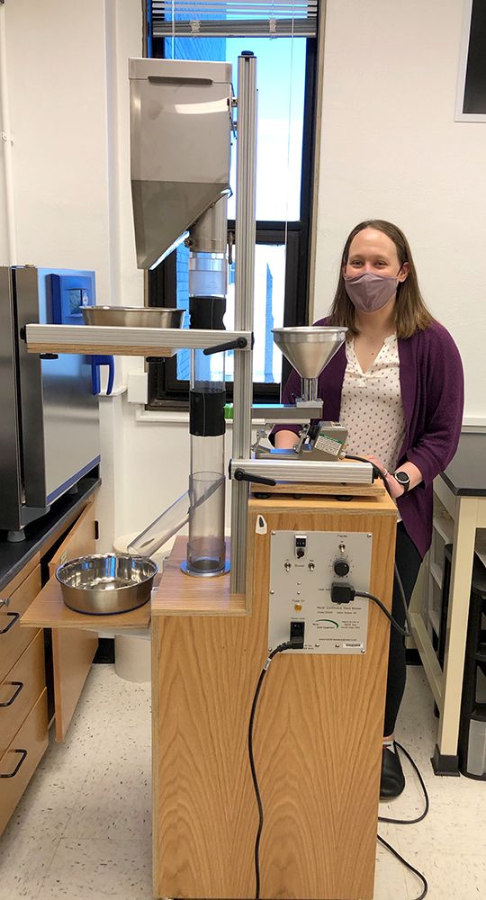 MU Assistant Professor in Biological Sciences Lauren Sullivan poses with a seed-sorter in her lab