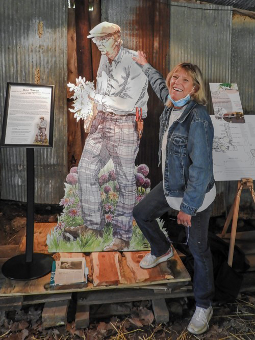 Julie Taven poses with a life-sized replica of her father commissioned by Bill Ruppert for the anniversary celebration.